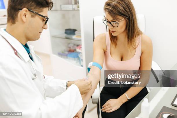 general practitioner doing blood test - drug testing stock pictures, royalty-free photos & images