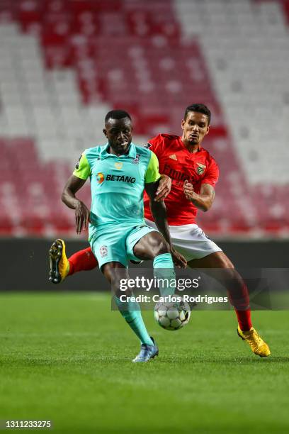 Lucas Verrissimo of SL Benfica tries to stop Joel Tagueu of CS Maritimo during the Liga NOS match between SL Benfica and CS Maritimo at Estadio da...