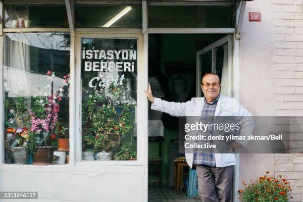 a barbershop owner in an old neighborhood of istanbul - door bell fotografías e imágenes de stock