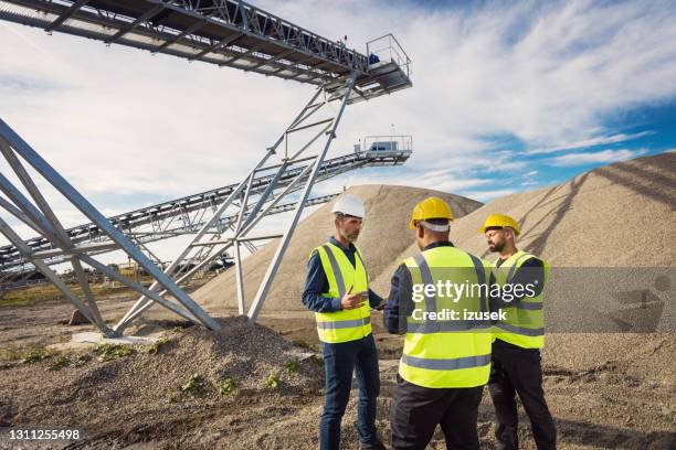 back view of open-pit mine workers - open pit mine stock pictures, royalty-free photos & images