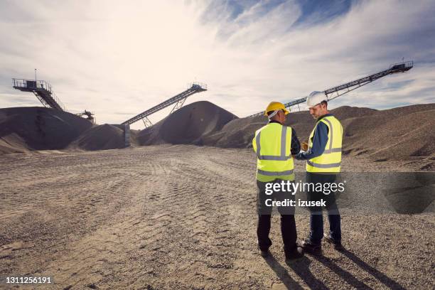 back view of open-pit mine workers - natural phenomenon stock pictures, royalty-free photos & images