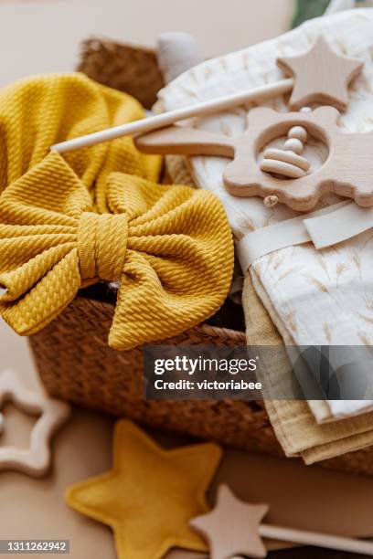 close-up of a basket filled with accessories for a newborn baby - gift hamper stock pictures, royalty-free photos & images