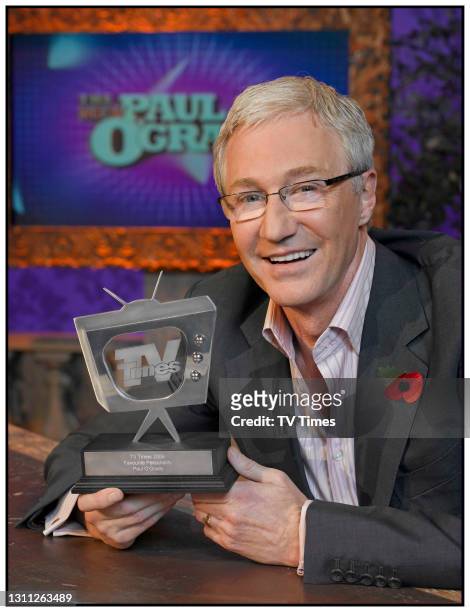 Television presenter Paul O'Grady posing with a TV Times award, circa summer 2006.