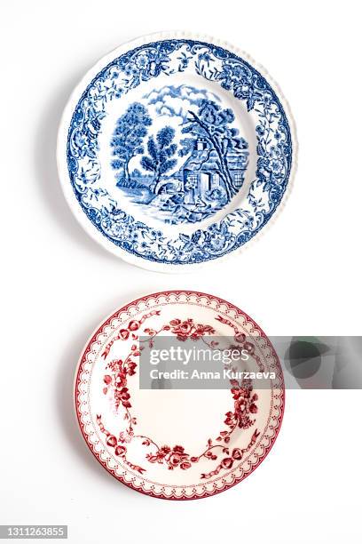 two empty plates isolated on white background. directly above view. - 2 runde stock-fotos und bilder