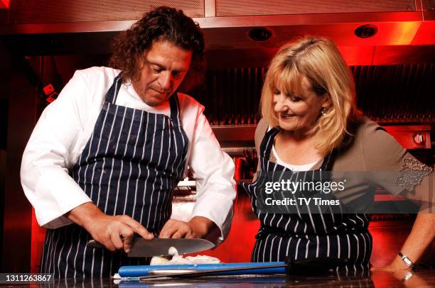 Chef and television personality Marco Pierre White chopping onions with a TV Times writer, August 16, 2007.