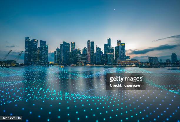 cityscape with abstract particles - singapore photos et images de collection