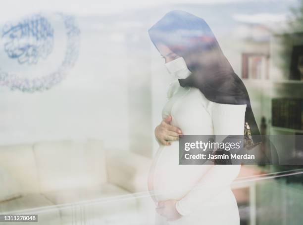 muslim pregnant woman with hijab and covid mask - pregnant muslim stock pictures, royalty-free photos & images