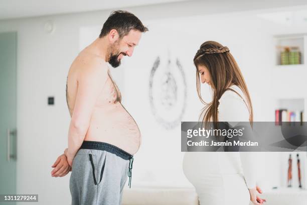 pregnancy for man and woman - fat couple stock pictures, royalty-free photos & images