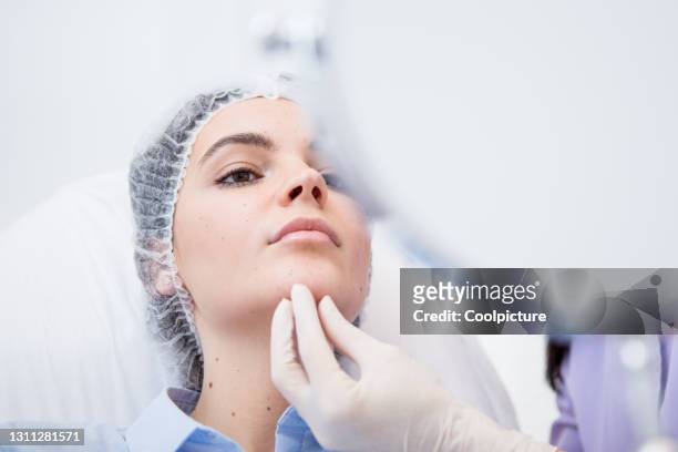 beauty clinic - skin examination - candid beautiful young woman face stock pictures, royalty-free photos & images
