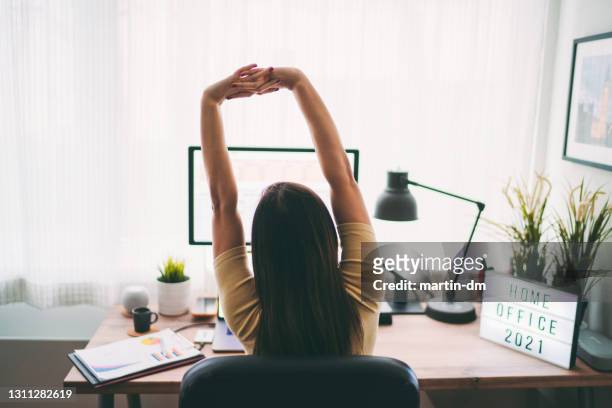 covid-19 home office - stretching at desk stock pictures, royalty-free photos & images