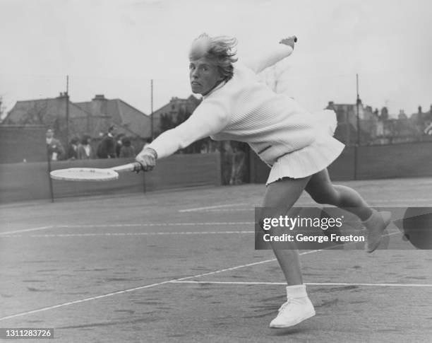 Ann Haydon-Jones of Great Britain watches the tennis ball while reaching to make a backhand return shot to Jenny Wagstaff during their Women's...