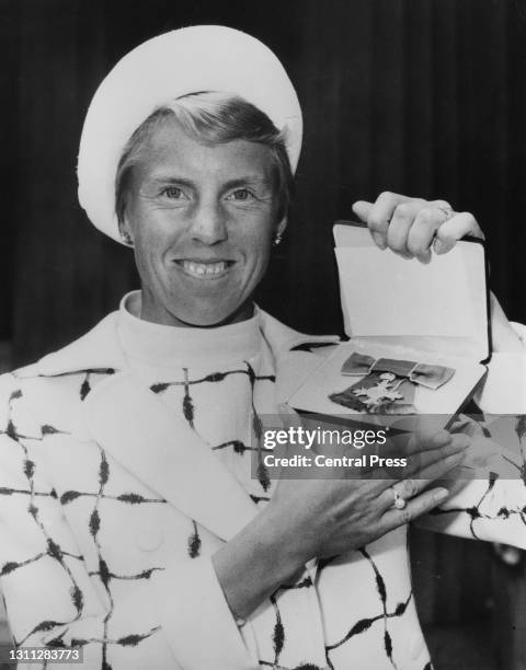 British tennis player Ann Haydon-Jones poses with the Member of the Most Excellent Order of the British Empire Medal for services to lawn tennis...