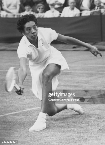Althea Gibson of the United States makes a forehand return to Edda Buding of Germany during their Women's Singles First Round match at the Wimbledon...