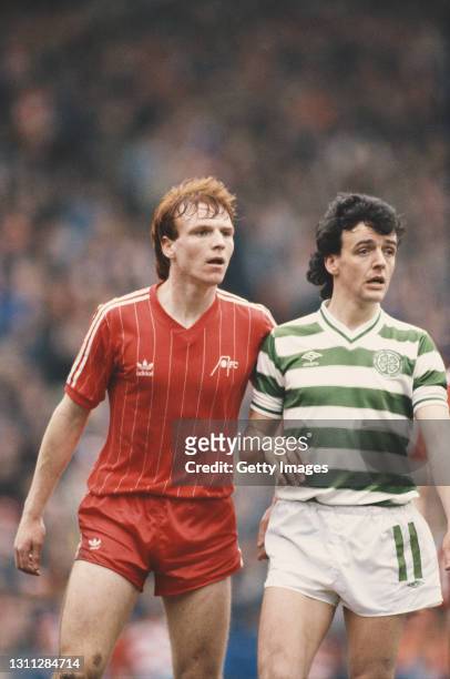 Aberdeen centre half Alex McLeish pictured with Celtic striker Frank McGarvey during a Scottish Premier League match circa 1983 in Scotland.