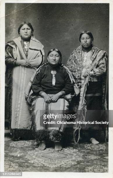 Postcard features a photograph of three unidentified woman from the Osage Nation, Pawhuska, Oklahoma Territory, circa 1918