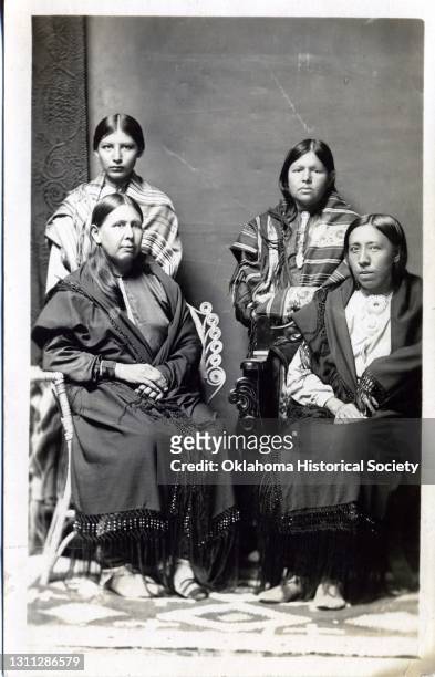 Postcard features a photograph of an unidentified women and three children of the Osage Nation, Pawhuska, Oklahoma Territory, circa 1918