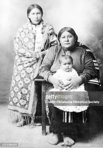 Postcard features a photograph of an unidentified women and two children of the Osage Nation, Pawhuska, Oklahoma Territory, circa 1918