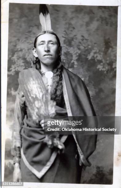 Postcard features a photograph of an unidentified man of the Osage Nation, Pawhuska, Oklahoma Territory, circa 1918