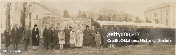 Portrait of US President Calvin Coolidge and unidentified representatives from the Osage Nation as they pose in front of the East Colonnade at the...