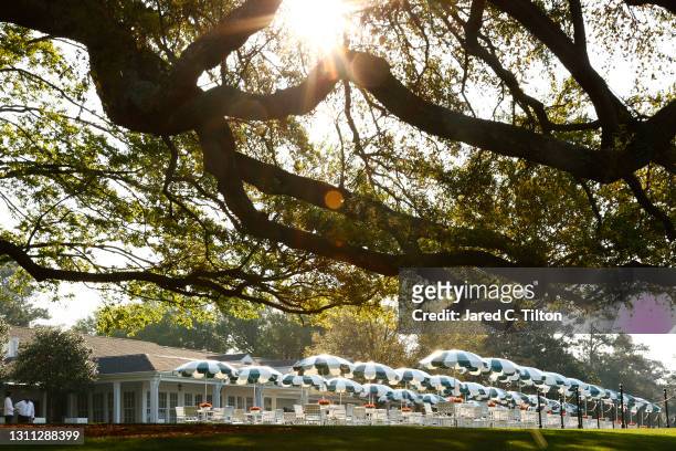 General view of the oak tree, umbrellas, chairs and tables in front of the clubhouse during a practice round prior to the Masters at Augusta National...