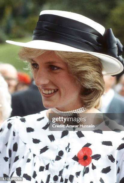 Diana, Princess of Wales, wearing a black and white patterned suit designed by Jan van Velden, a white hat with a black band designed by John Boyd, a...