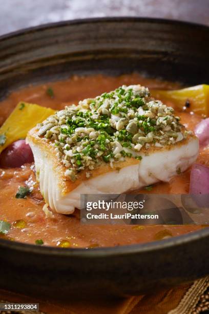 pan seared halibut with pumpkin seed gremolata with a coconut curry sauce - halibut stock pictures, royalty-free photos & images