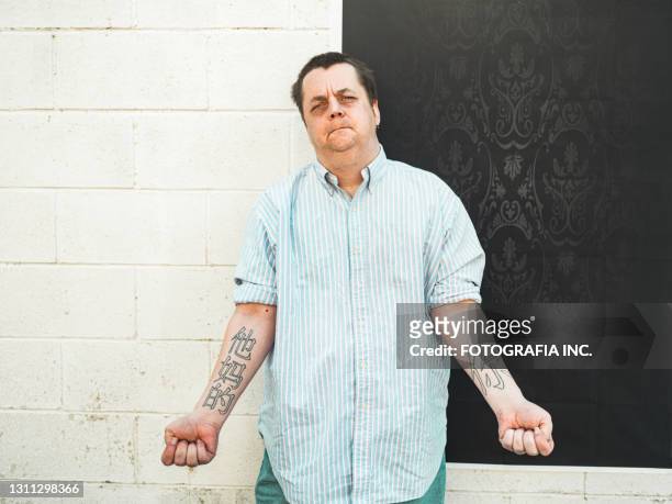 portrait of gay man against wall and backdrop - overweight 40 year old male concerned stock pictures, royalty-free photos & images