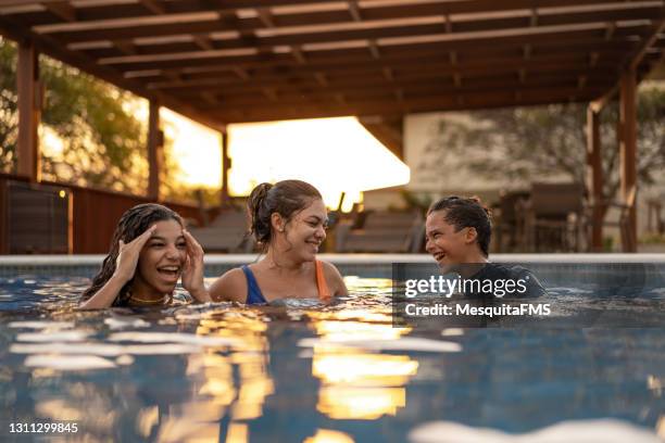 poolparty bei sonnenuntergang - brazilian family stock-fotos und bilder