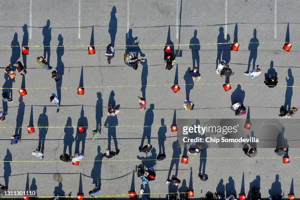 In an aerial view, some of the hundreds of people without appointments stand in line outside the mass coronavirus vaccination site at Hagerstown...