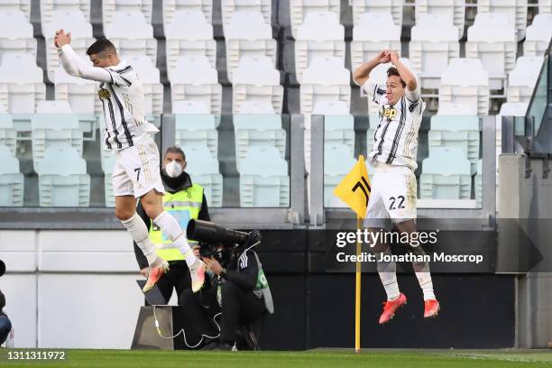 Cristiano Ronaldo of Juventus celebrates with team mate Federico Chiesa after scoring to give the side a 1-0 lead during the Serie A match between...