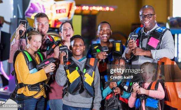 two families ready to play laser tag - playing tag stock pictures, royalty-free photos & images