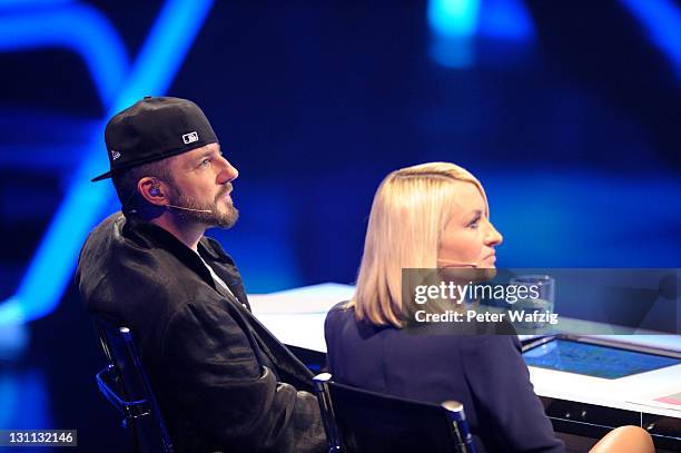 Jury members Mirko Bogojevic and Sarah Connor listen to a performance during 'The X Factor Live' TV-Show on November 01, 2011 in Cologne, Germany.