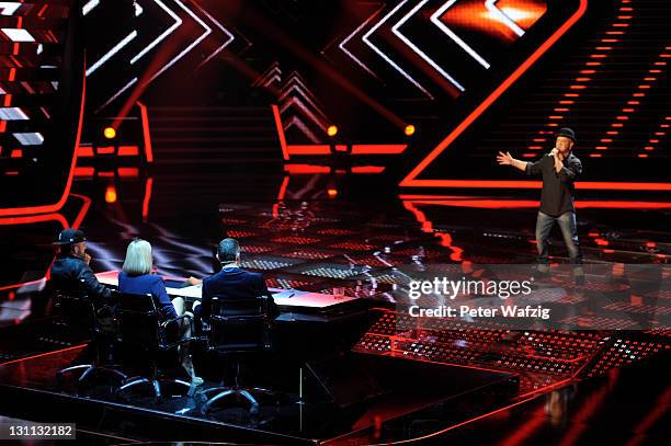 The jury listens to Volker Schlag, performing on stage in the decision round during 'The X Factor Live' TV-Show on November 01, 2011 in Cologne,...