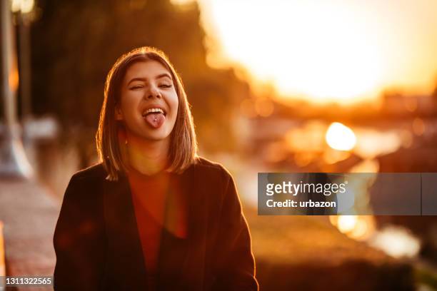 woman sticking out pierced tongue and making a silly face - pierced stock pictures, royalty-free photos & images