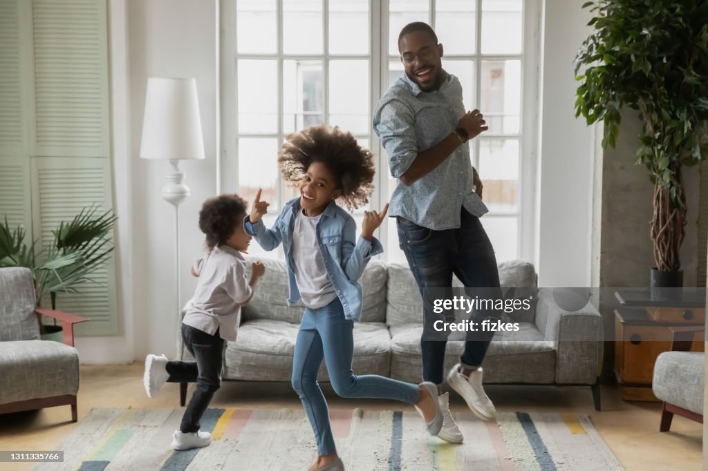 Cool daddy entertaining two children at home