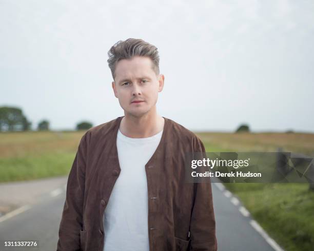 English pop singer and musician Tom Chaplin pictured during a photo session on a deserted road at Birling Gap, near Eastbourne, to promote his solo...