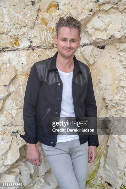 English pop singer and musician Tom Chaplin pictured on the pebble beach at Birling Gap, near the resort town of Eastbourne during a photo shoot to...