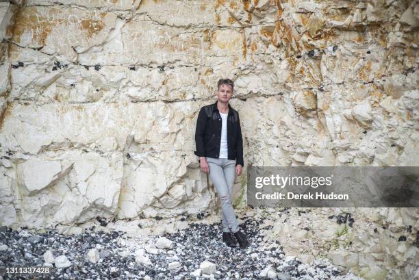 English pop singer and musician Tom Chaplin pictured on the pebble beach at Birling Gap, near the resort town of Eastbourne during a photo shoot to...