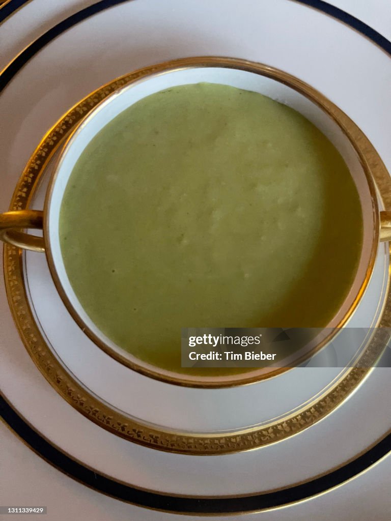 Fresh pea cucumber mint gazpacho soup in an elegant china bowl