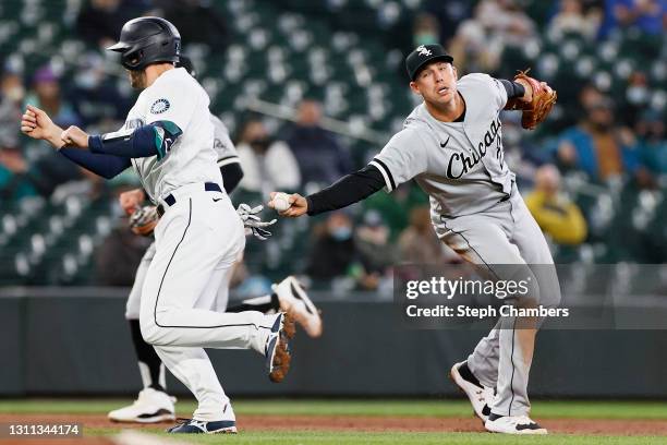 Tom Murphy of the Seattle Mariners is tagged out by Jake Lamb of the Chicago White Sox in the third inning at T-Mobile Park on April 07, 2021 in...