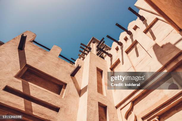 traditional arabic style building against blue sky - uae heritage stock pictures, royalty-free photos & images