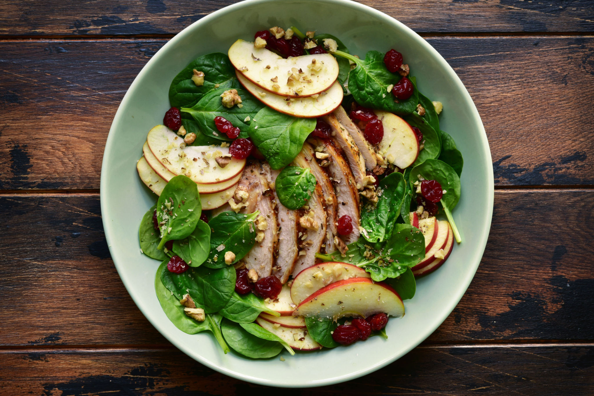 Fresh salad with baby spinach, apple, grillead turkey and dried cranberry Fresh salad with baby spinach, apple, grillead turkey and dried cranberry