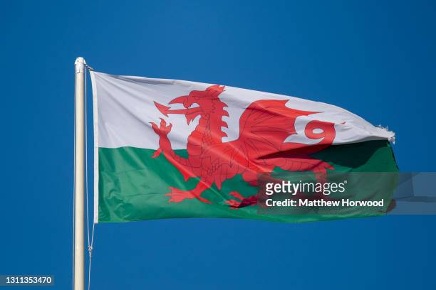 Close-up of the Wales national flag against a blue sky on March 8, 2021 in Cardiff, Wales. The 2021 Senedd election will be the sixth held since...