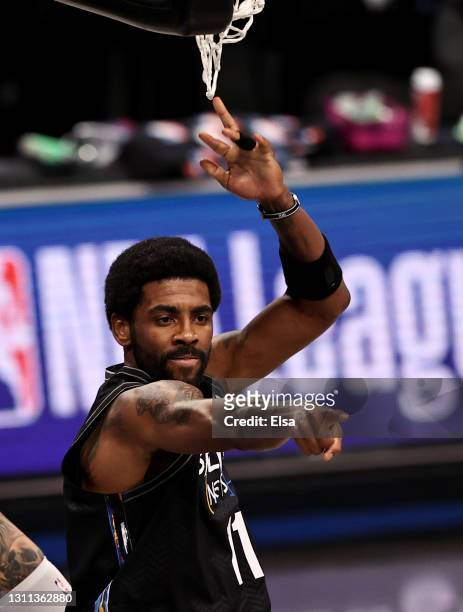Kyrie Irving of the Brooklyn Nets celebrates his dunk in the first quarter against the New Orleans Pelicans at Barclays Center on April 07, 2021 in...