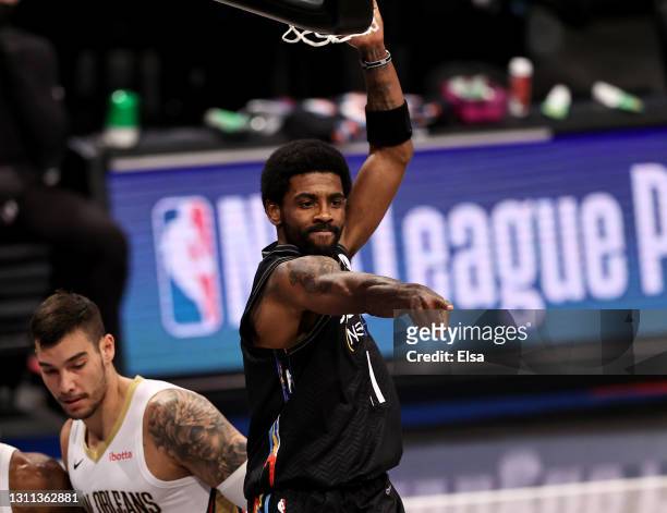 Kyrie Irving of the Brooklyn Nets celebrates his dunk in the first quarter against the New Orleans Pelicans at Barclays Center on April 07, 2021 in...