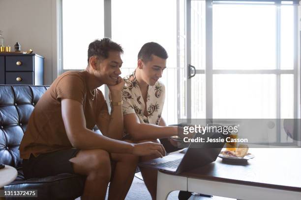 gay couple working together from home - auckland covid stock pictures, royalty-free photos & images