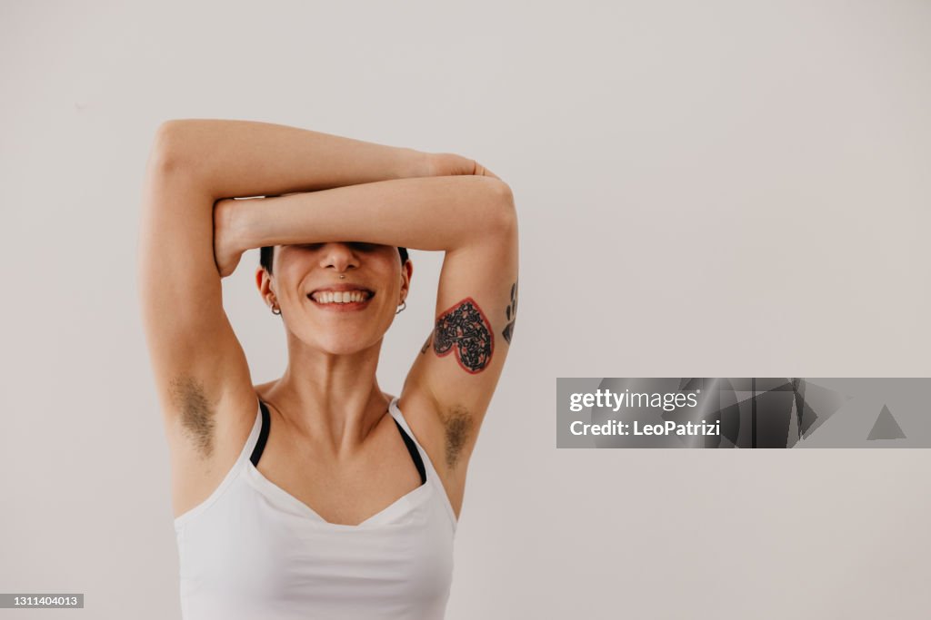 Young woman portrait showing armpit hair