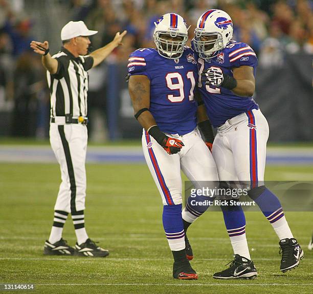 Spencer Johnson and Marcell Dareus of the Buffalo Bills celebrate Dareus' block of a field goal attempt by the Washington Redskins at Rogers Centre...