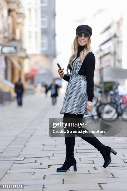 German actress Lara-Isabelle Rentinck wearing a light blue, black and white checkered mini dress by Zara, black tights by Wolford, black knee high...