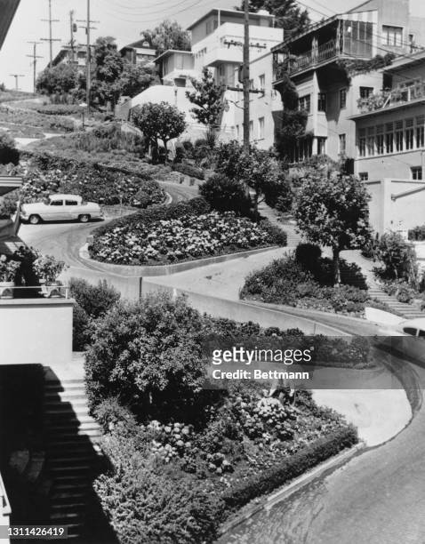 Car winds its way around the flower beds in the hairpin bends of Lombard Street, labelled 'the crookedest street in the world', a steep, one-block...